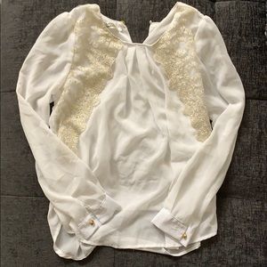 Long-sleeved blouse with gold accents